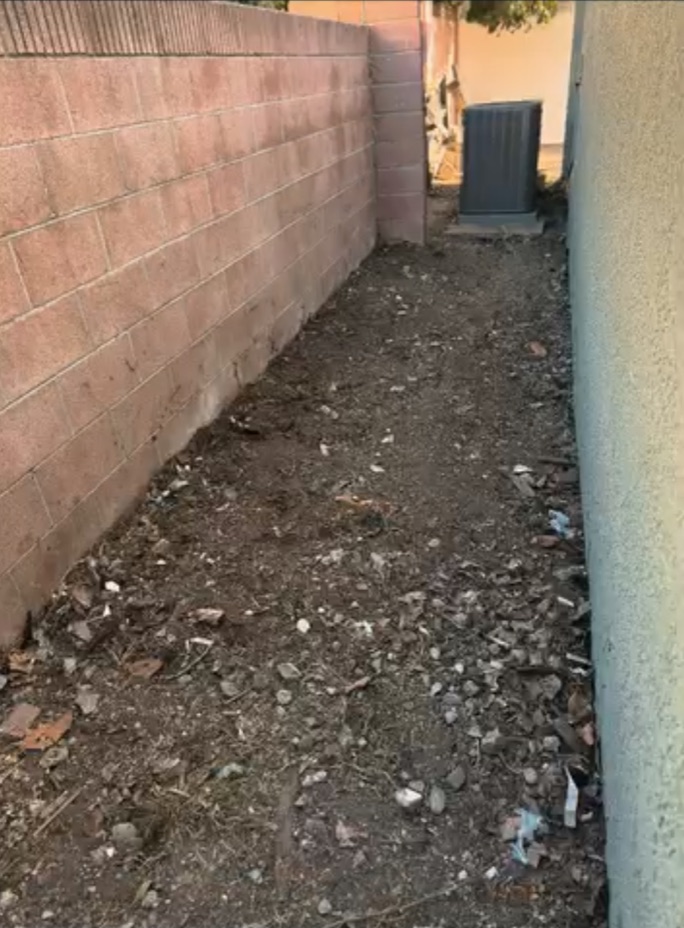 Same side yard cleared of the masonry, lumber and debris after cleanup